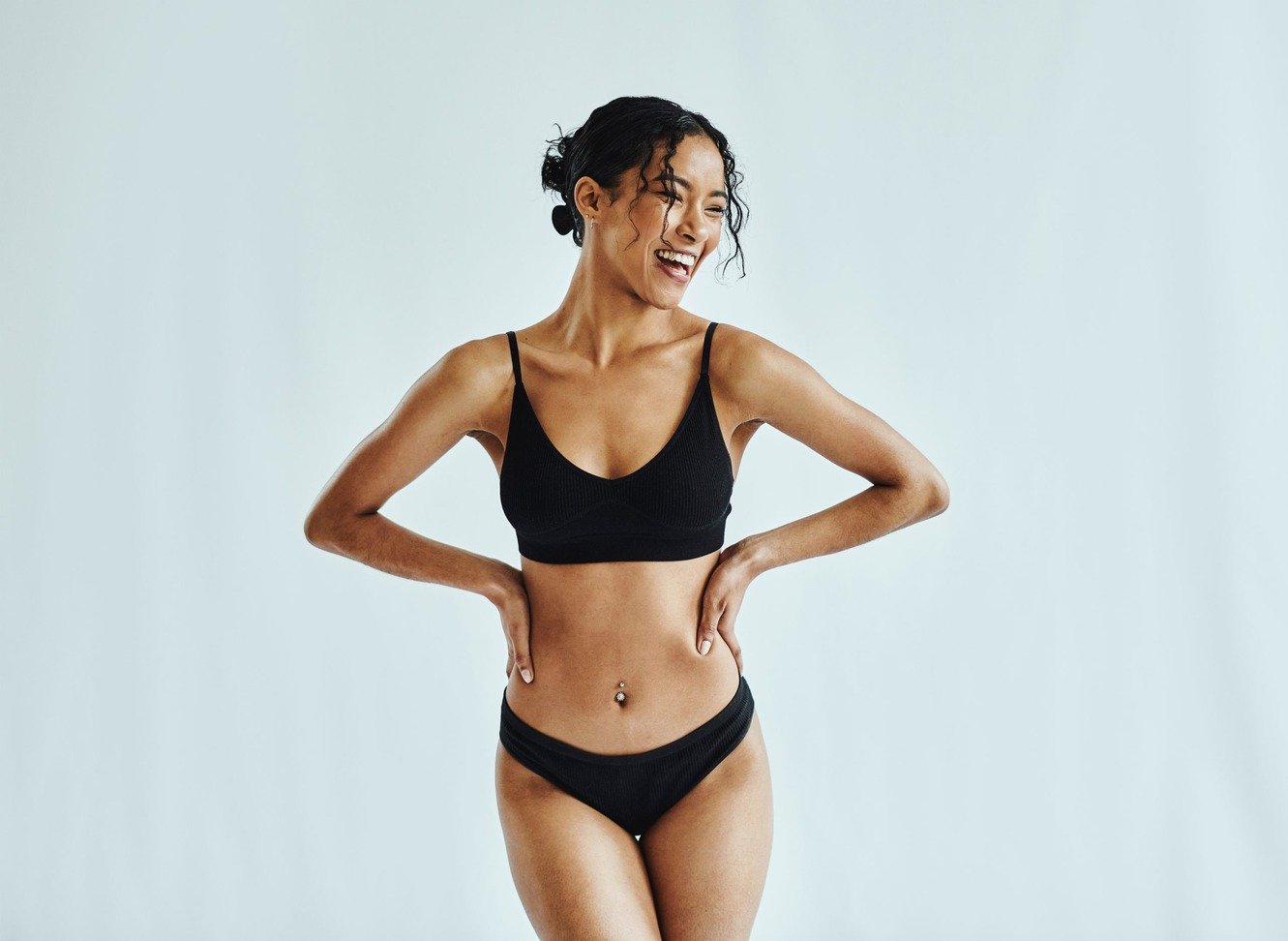 Happy health woman standing appreciating her body