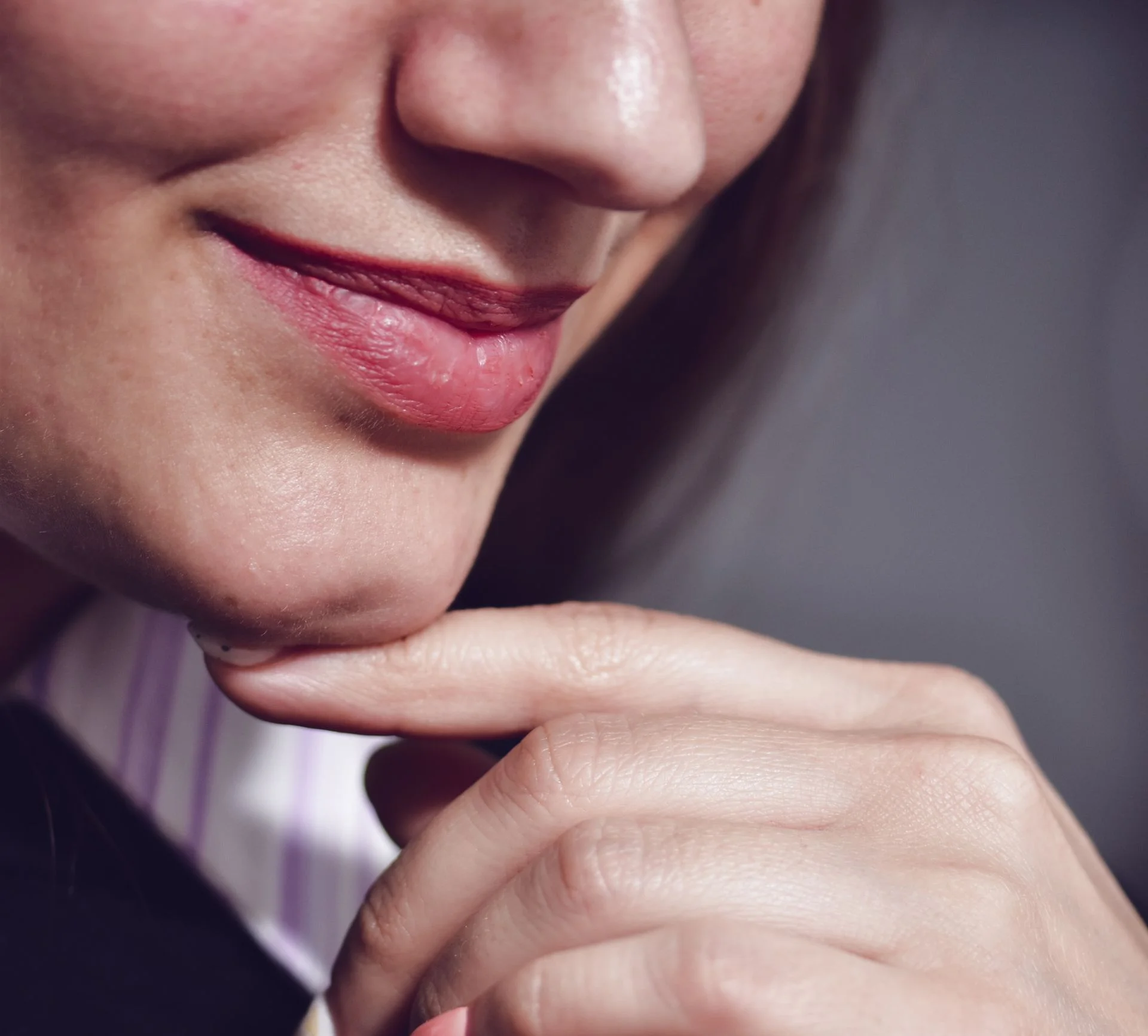 Close up of woman smiling and touching her chin