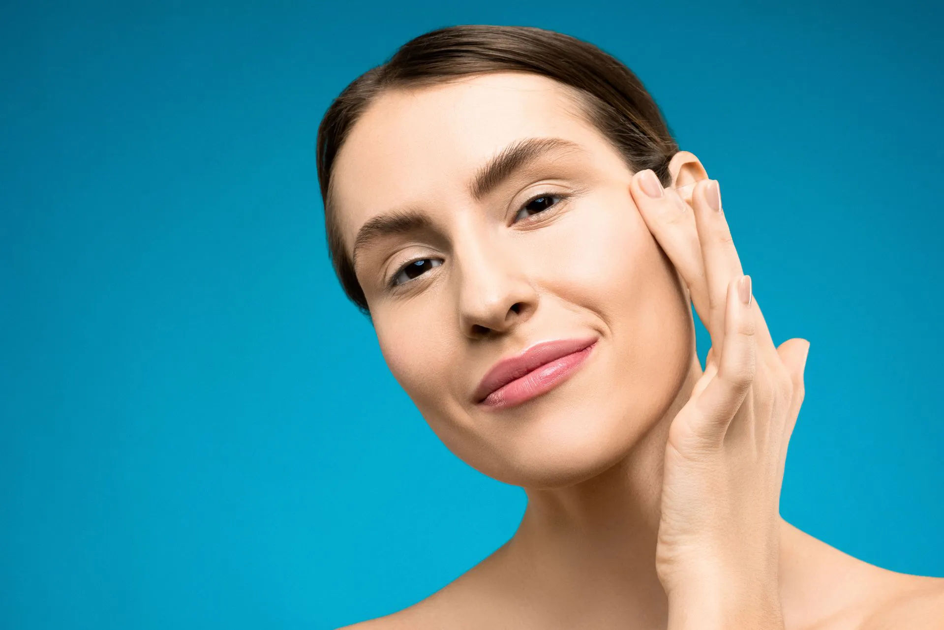 Woman touching her face and smooth skin