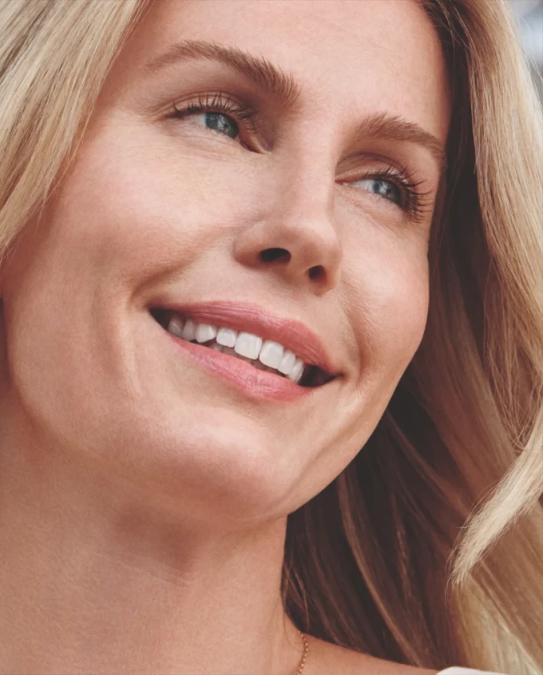 Woman with smooth skin smiling after Sculptra treatment