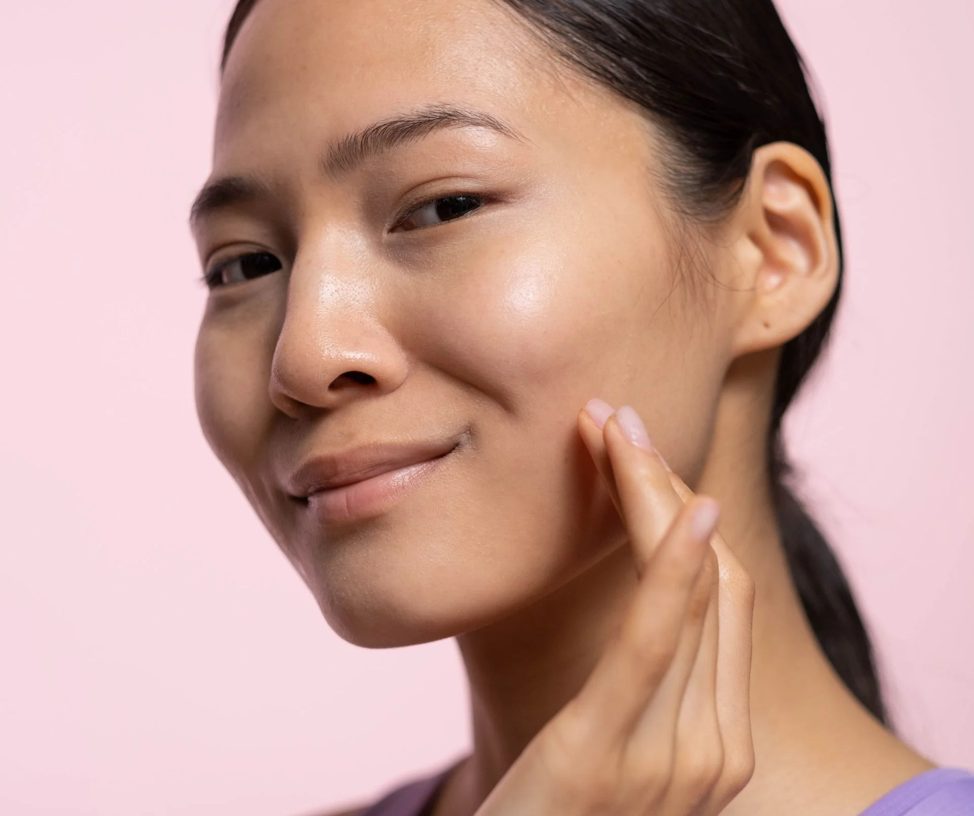 Woman touching cheek smooth skin